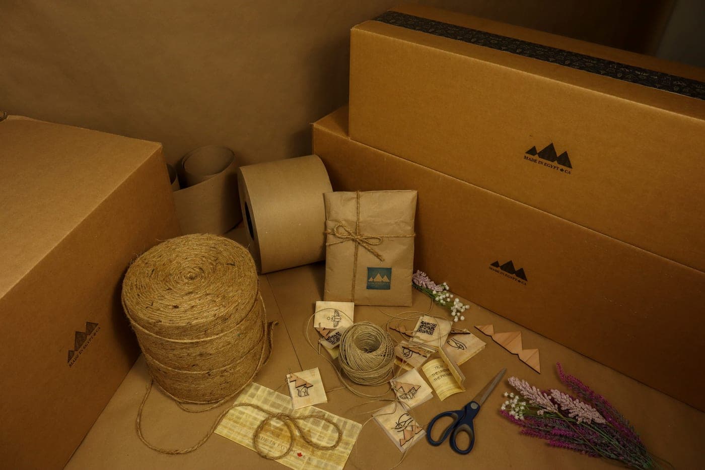 Boxes, kraft paper and twine laid out for wrapping