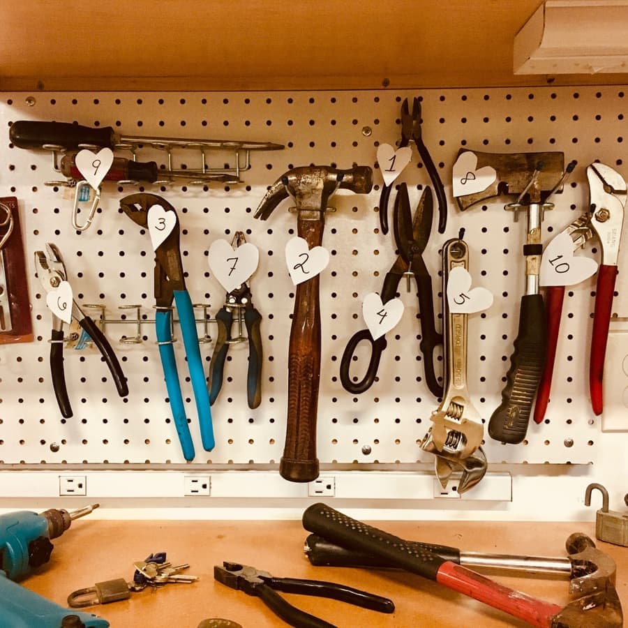 Illustrative stock photo: hand tools arranged on a workshop pegboard