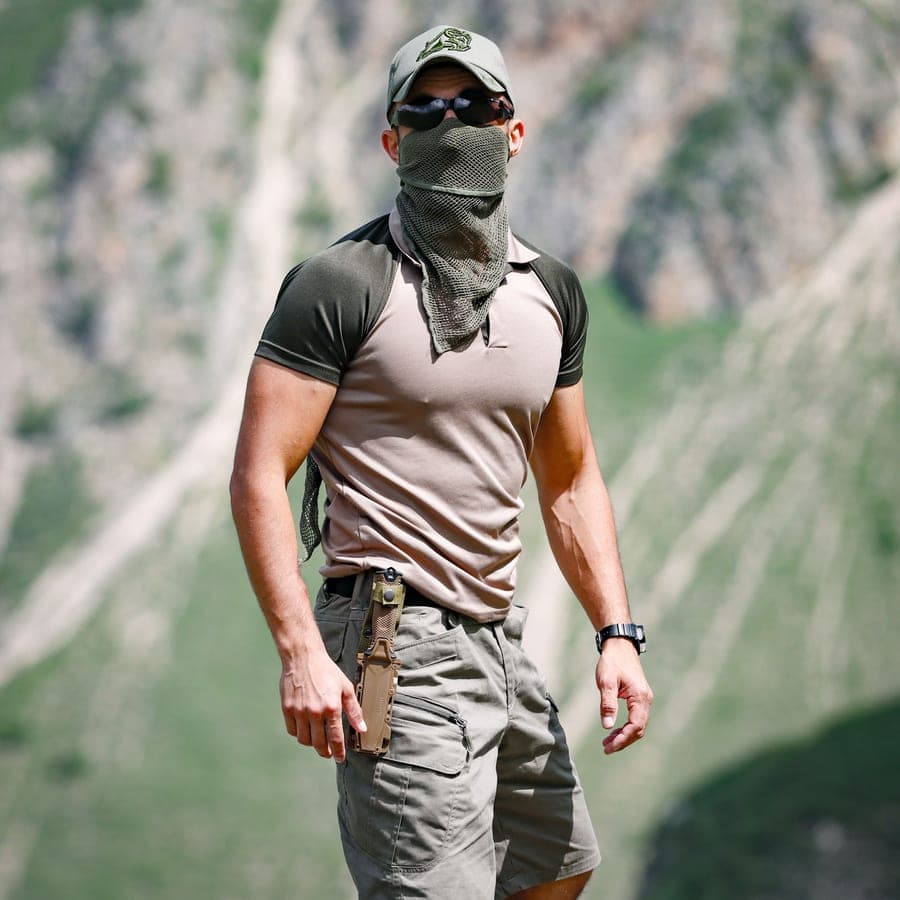 Illustrative stock photo: a man outdoors in a cap and a neck gaiter